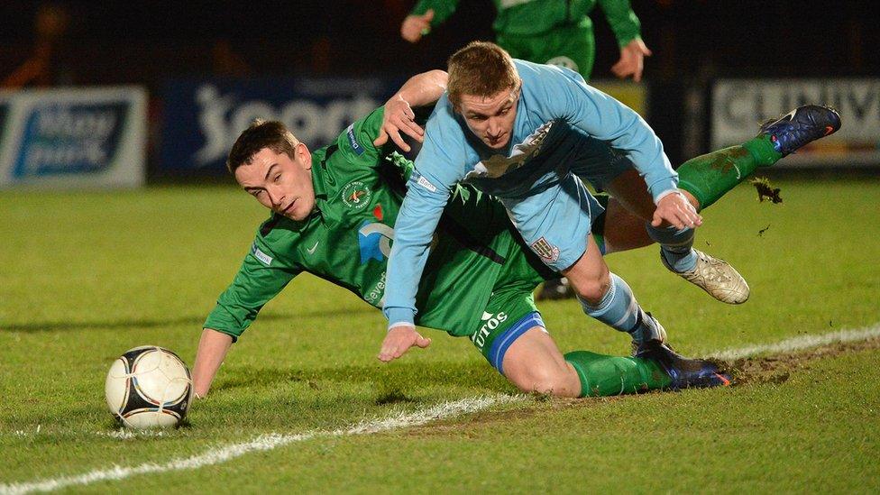 Chris Curran of Ballinamallard in action against Ballymena United's Ally Teggart