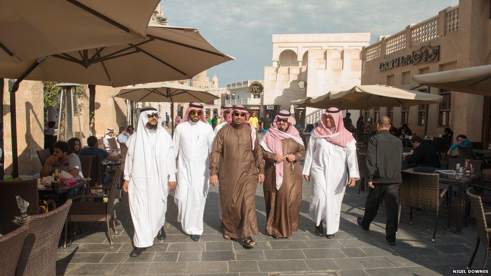 Saudi Arabian visitors stroll through Souk Waqif, home to many traditional Arabic restaurants and a focal point for visitors, local families and tourists.