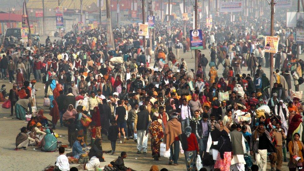 Devotees arrive for a dip at Sangam, the confluence of the Rivers Ganges, Yamuna and mythical Saraswati, on the first day of the Kumbh Mela