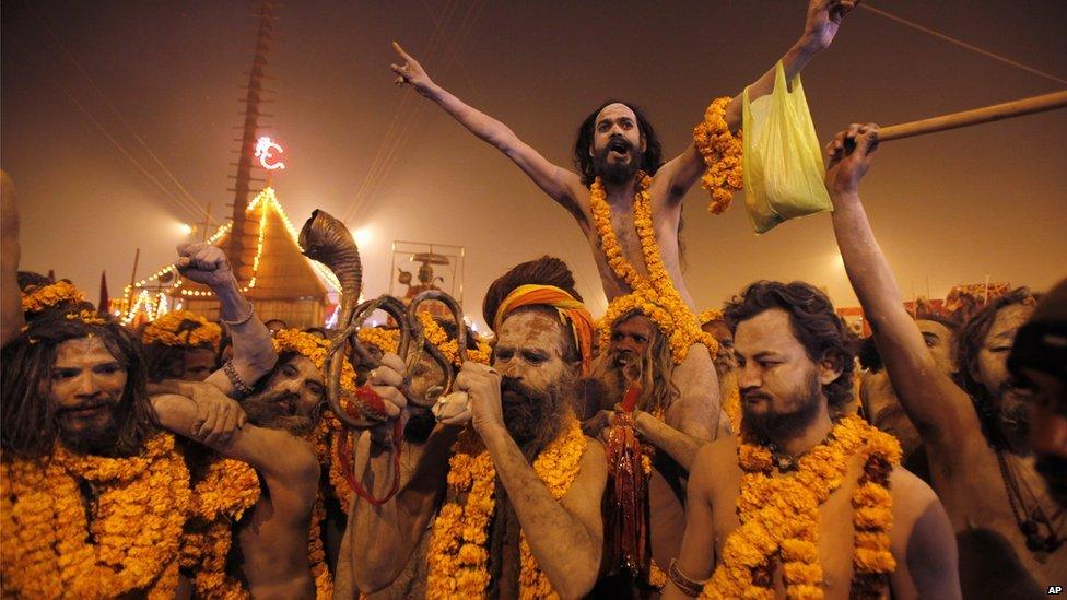 Naked Hindu holy men or Naga sadhus leave from their camp for a dip at Sangam, the confluence of the Rivers Ganges, Yamuna and mythical Saraswati on the first day of the Kumbh Mela