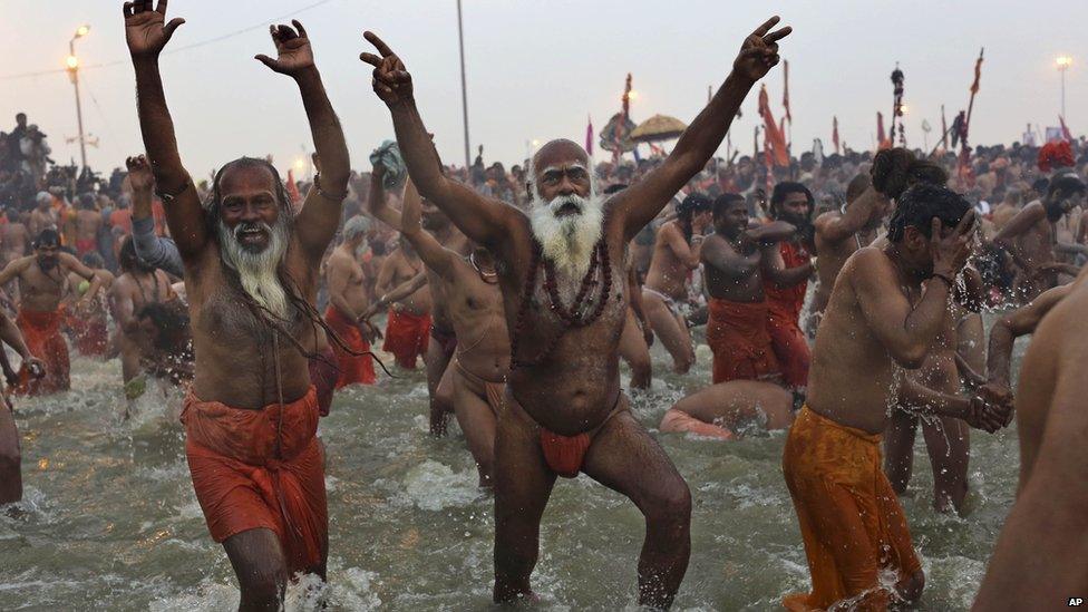 Sadhus, run into the water at Sangam, the confluence of the rivers Ganges, Yamuna and mythical Saraswati, during the royal bath on Makar Sankranti at the start of the Maha Kumbh Mela in Allahabad, India