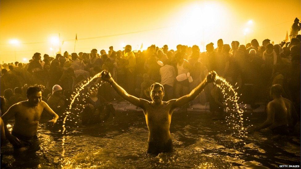 Hindu devotees bathe in the waters of the Ganges river during the auspicious royal bathing day of Makar Sankranti, the start of the Maha Kumbh Mela, in Allahabad, India, 14 January 2013