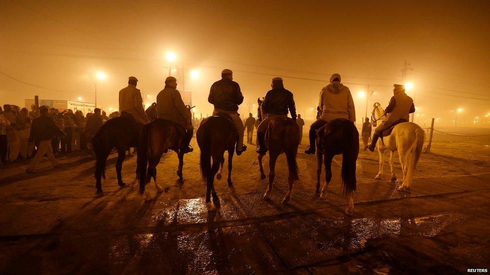 Mounted policemen patrol during the first grand bath in Allahabad, 14 January 2013