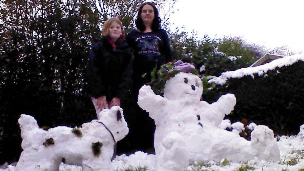 A snow girl and a snow dog.