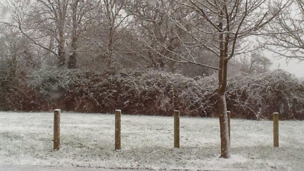 Snow falling outside a house