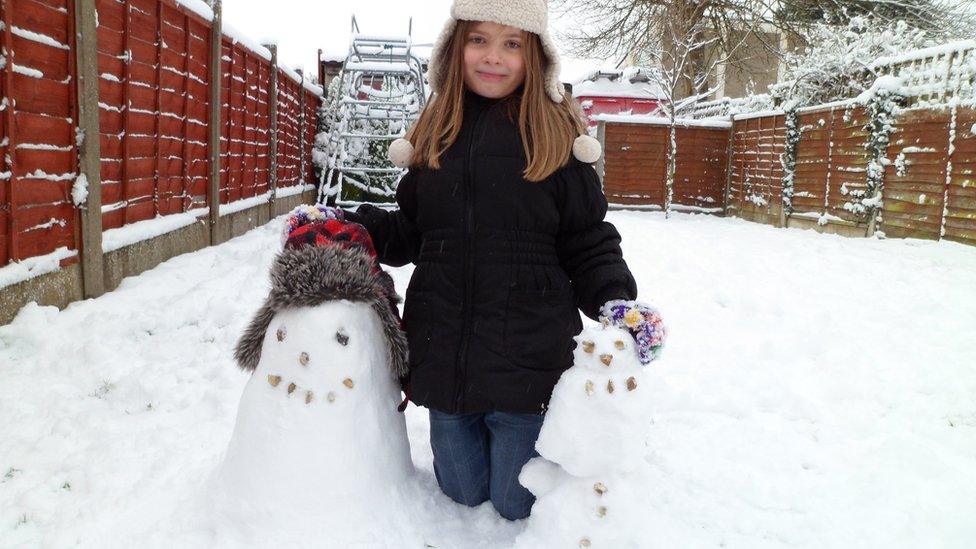 A girl with her snowmen.