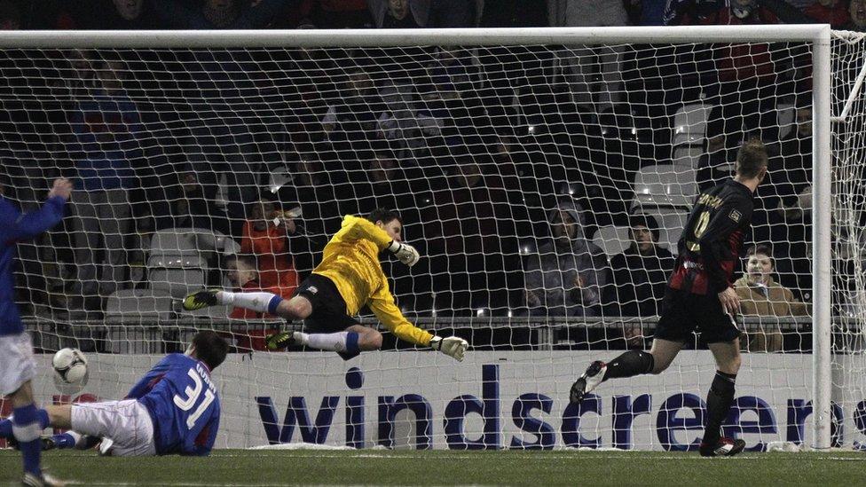 Crusaders striker Timmy Adamson scores past Linfield keeper Ross Glendinning to secure a place in the sixth round of the Irish Cup