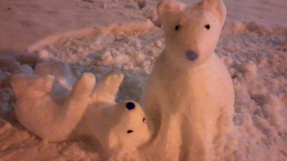 Two polar bears made of snow.