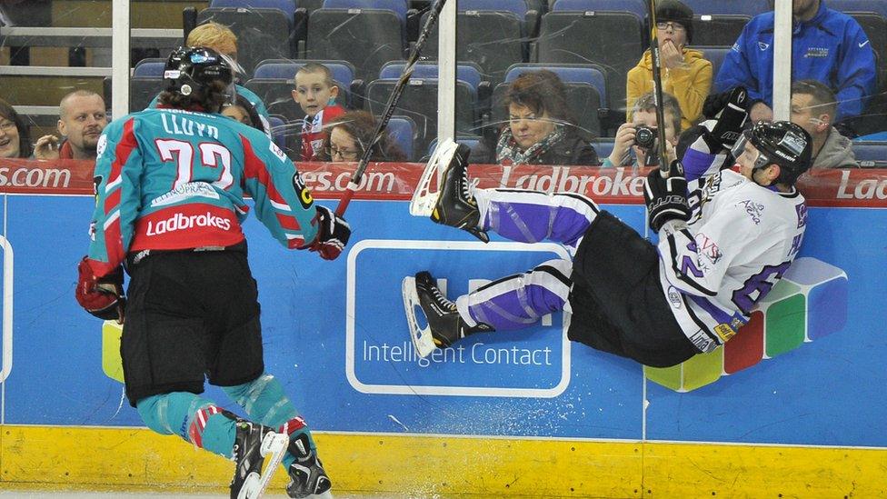 Darryl Lloyd of the Giants sends Kevin Phillips of the Braehead Clan flying in a check during the Elite League game in Belfast