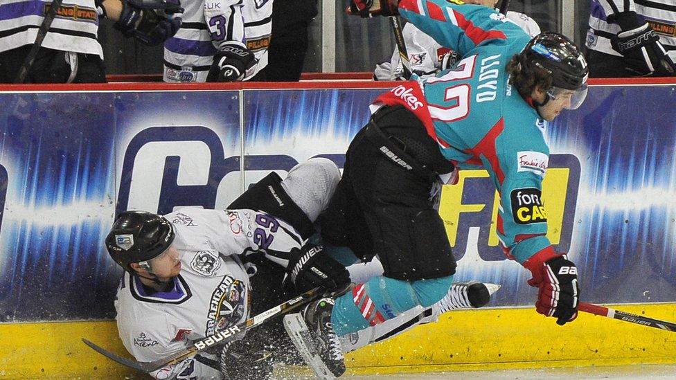 Darryl Lloyd of the Belfast Giants checks Adam Walker of the Braehead Clan during the Elite League game