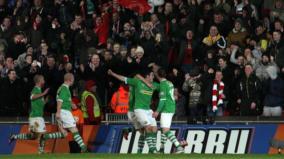 Diarmuid O'Carroll celebrates in front of the Cliftonville fans after scoring the opener