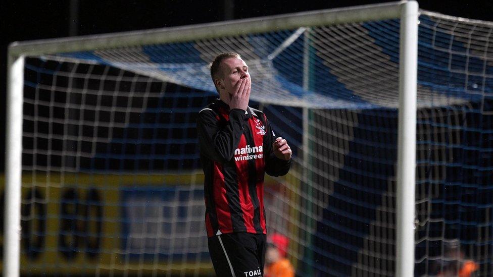 Crusaders forward Jordan Owens misses an early chance in the Windsor Park decider