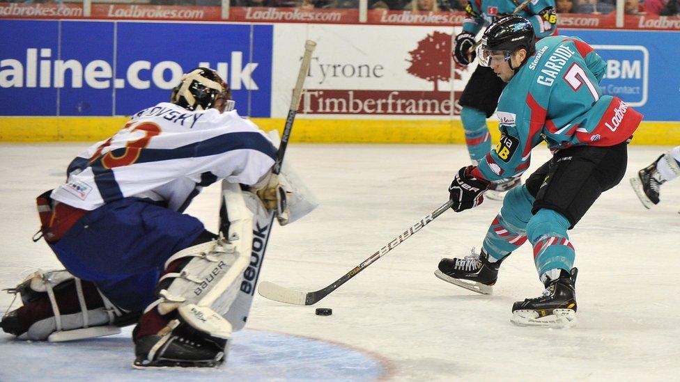 Mark Garside of the Belfast Giants scores the first goal past Tomas Hiadlousky