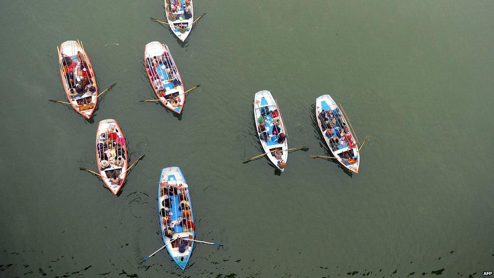 Boats carry people to Sangam