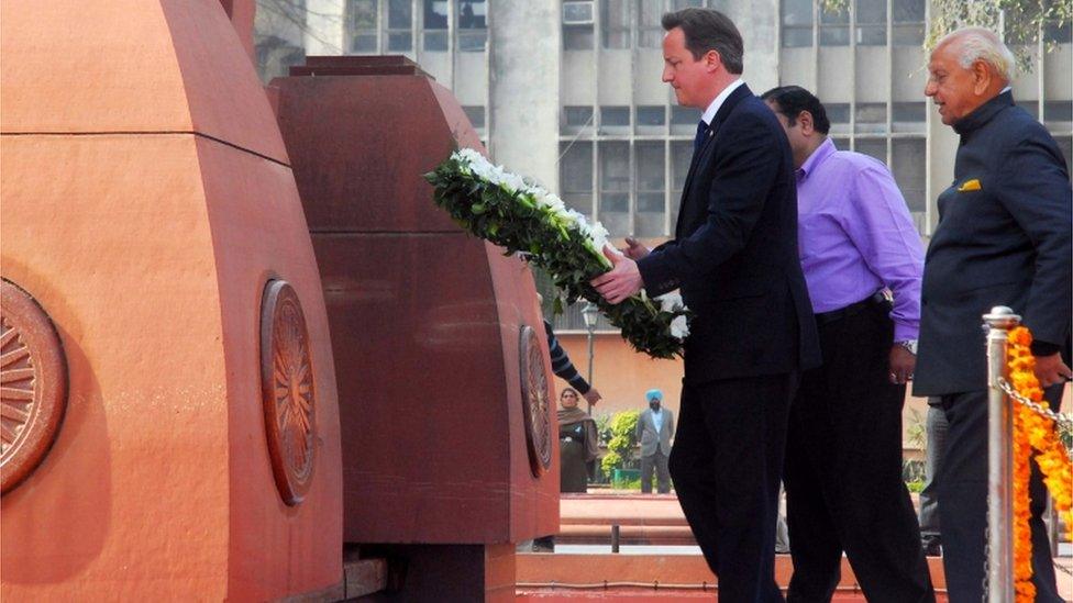 British Prime Minister David Cameron walks to lay a wreath at the site of a notorious 1919 massacre of hundreds of Indians by British colonial forces, in Amritsar, India, Wednesday, Feb. 20, 2013