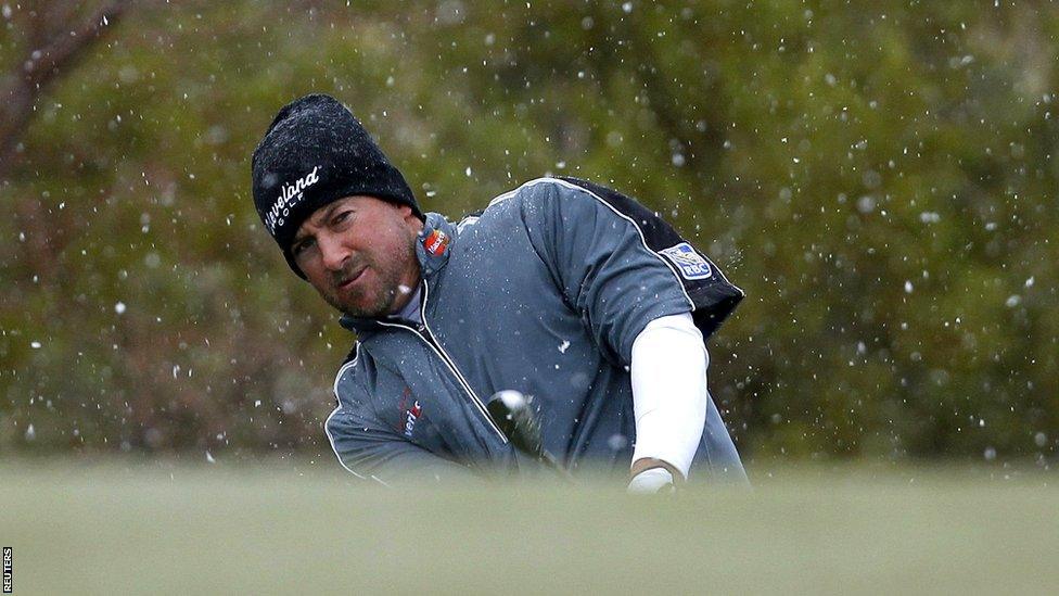 Graeme McDowell chips in the snow