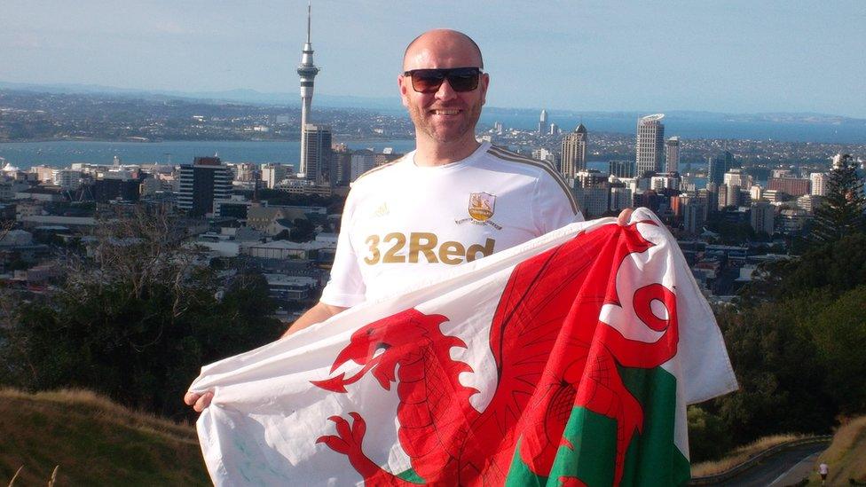 Swansea boy Dean Williams standing on top of Mount Eden with the city of Auckland, New Zealand behind