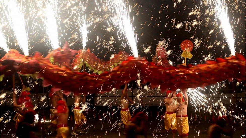 Dragon dancers perform amid fireworks in Yongchuan district in Chongqing in southwest China