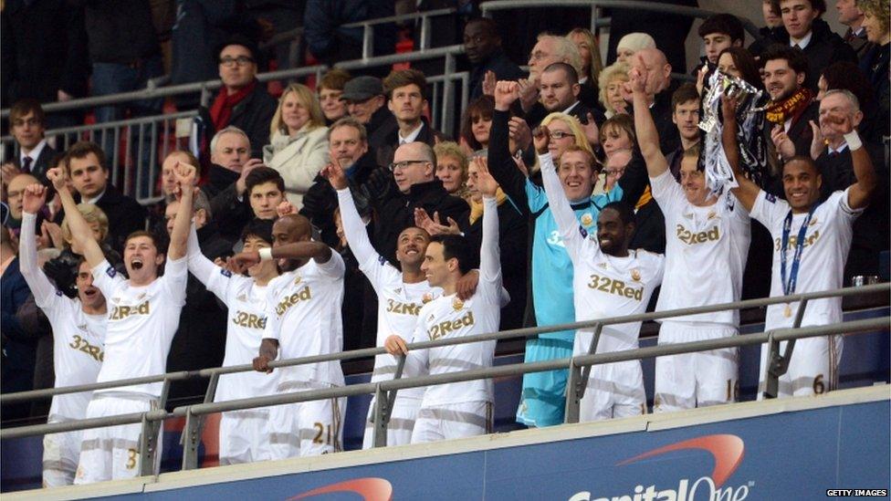 Swansea City players celebrate after their historic Capital One Cup five-nil victory over Bradford City at Wembley