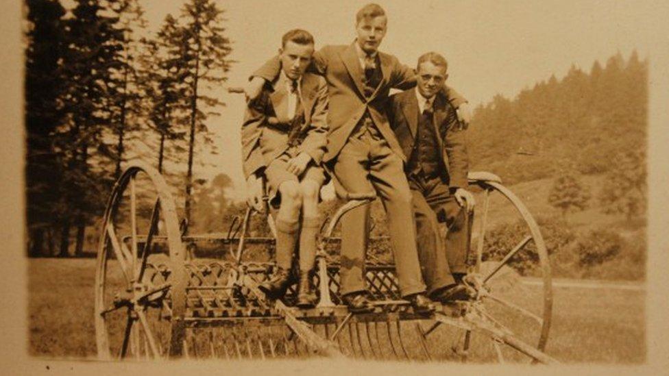 This photo shows three men sitting on farm machinery c1930s