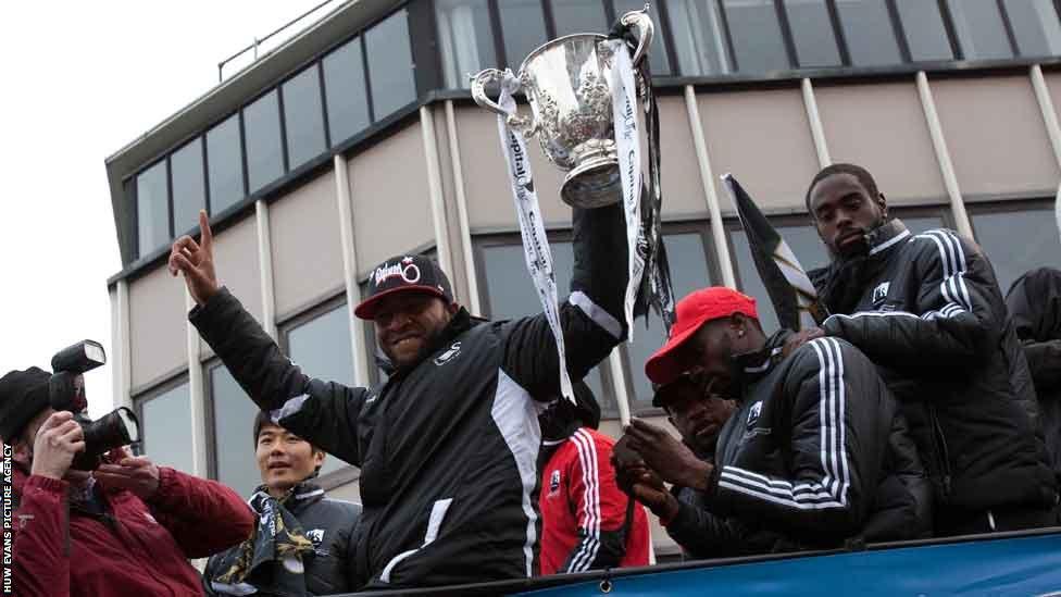 Swansea players proudly show off the Capital One Cup
