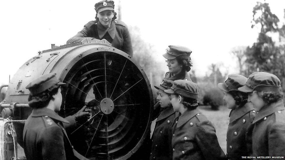 Archive photograph of capped women with searchlight