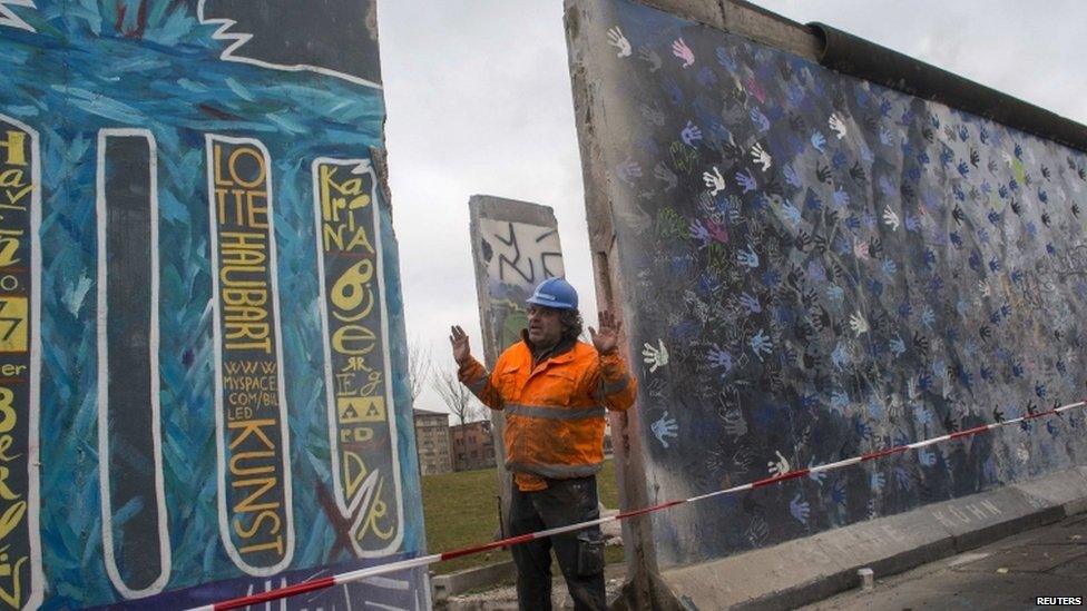 A builder works on the Berlin Wall, Germany