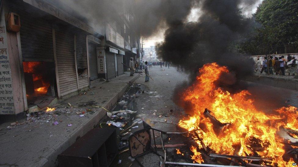 Fire lit by protesters in Bogra, Bangladesh