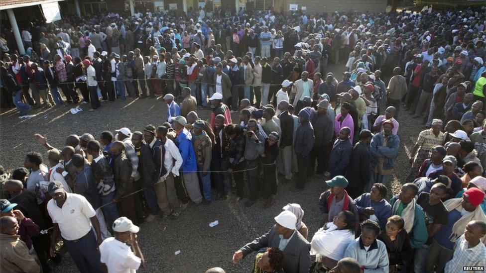Voters wait in line to cast their ballots in a school yard in the Mlango Kubwa ward of Nairobi, March 4, 2013.