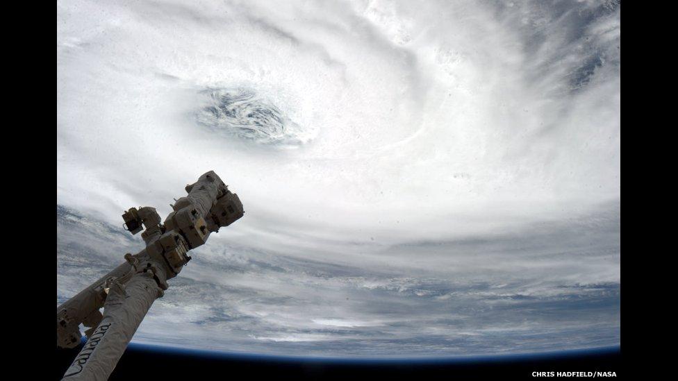 Eye of the Storm - Tropical Cyclone Haruna, over Madagascar, with Canadarm2 pointing at the eye