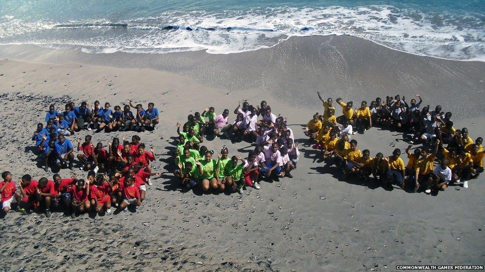 Primary schoolchildren from Anguilla pose on the beach at Crocus Bay