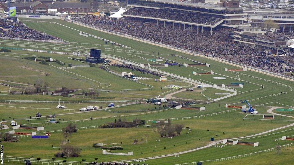 Crowds pack the stands in the background of this panoramic view of Cheltenham racecourse