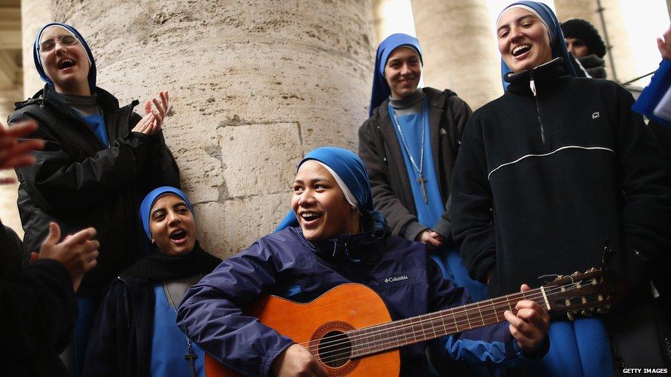 Nuns sing hymns under the colonnade in St Peter's Square in Vatican City.