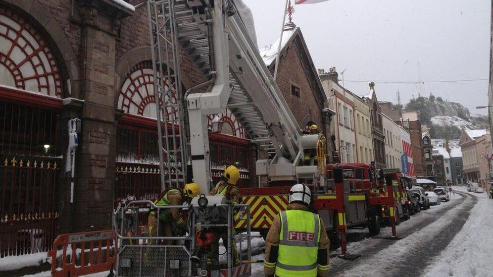 Jersey Fire officers removing ice from the town market