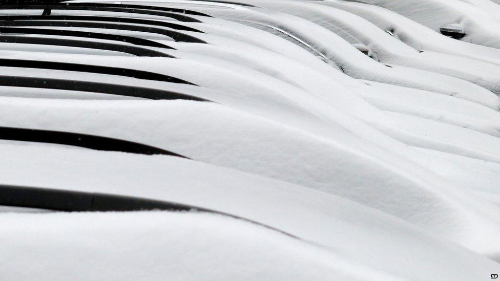 Snow blankets cars in Duesseldorf, Germany, 12 March