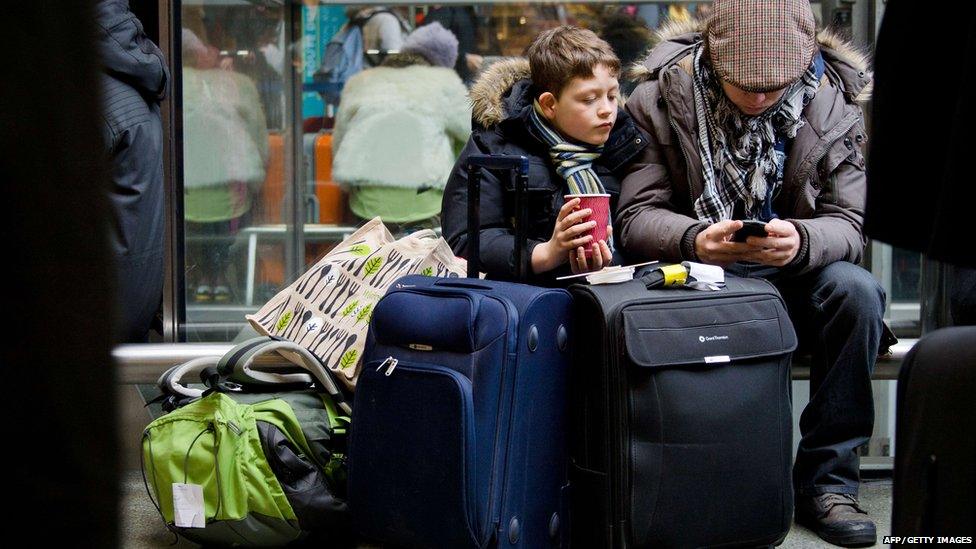 Travellers queue at the ticket office in Saint Pancras international train station, central London