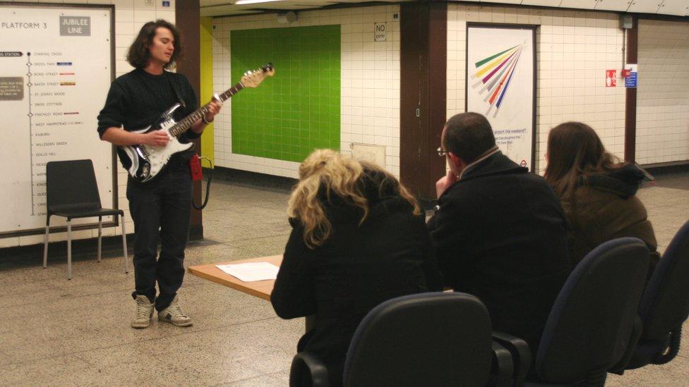 Ben Hudson performs in front of the panel