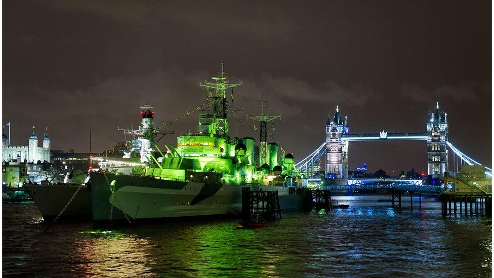 HMS Belfast on the River Thames in London has donned a coat of green