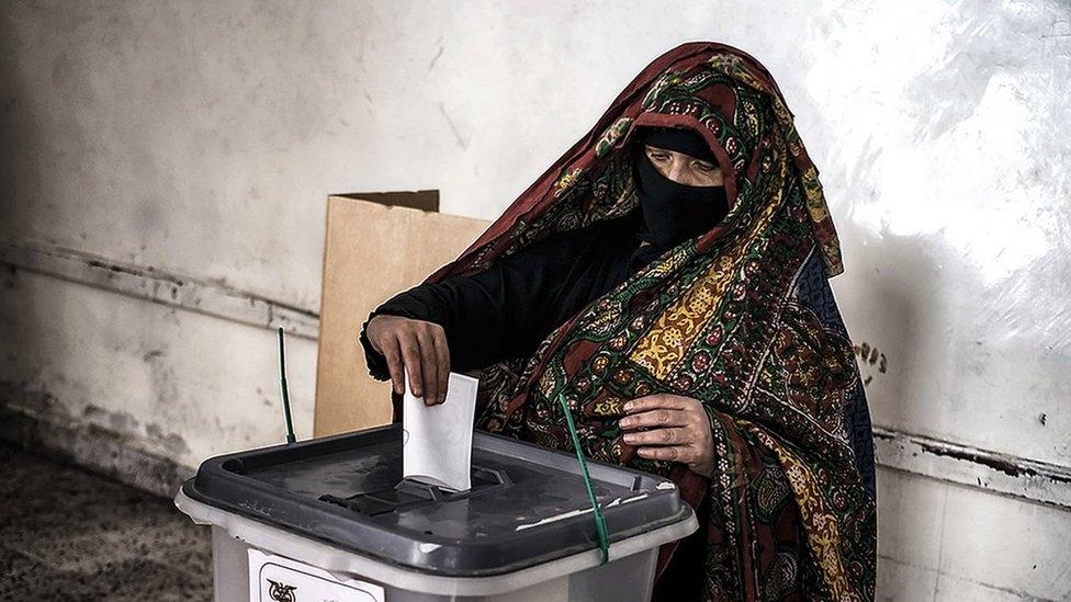 Woman votes in Sanaa's old city