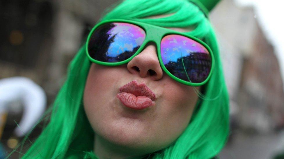 Woman in green wig and sunglasses