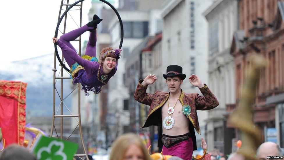 Trapeze artist and stilt walker