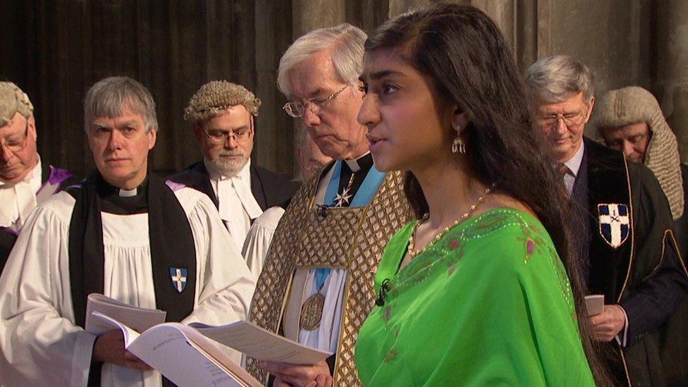 Evangeline Kanagasooriam questions the Archbishop as he enters the cathedral.