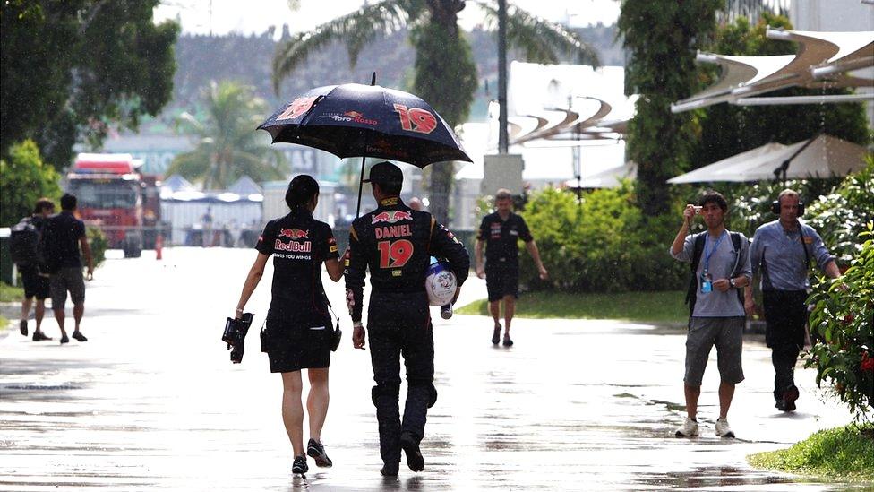 Daniel Ricciardo (19) is escorted back from a media session by Toro Rosso's press officer.