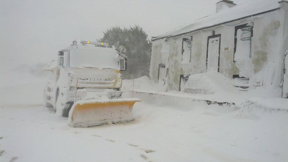 A snow plough and buildings in a snow drift. Photo: Matthew Wood