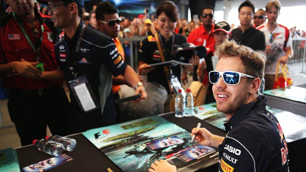 Sebastian Vettel signs autographs for fans