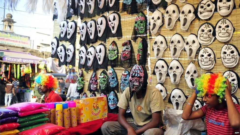 An Indian vendor waits for customers at a roadside stall ahead of Holi festival in Allahabad on March 24, 2013.