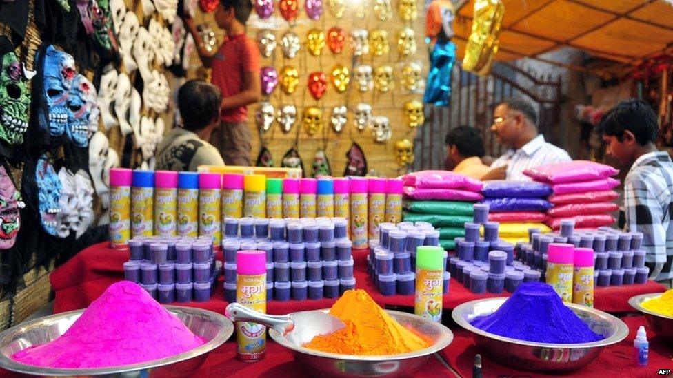 Bowls of coloured powder are displayed at a roadside shop ahead of Holi festival in Allahabad on March 24, 2013.