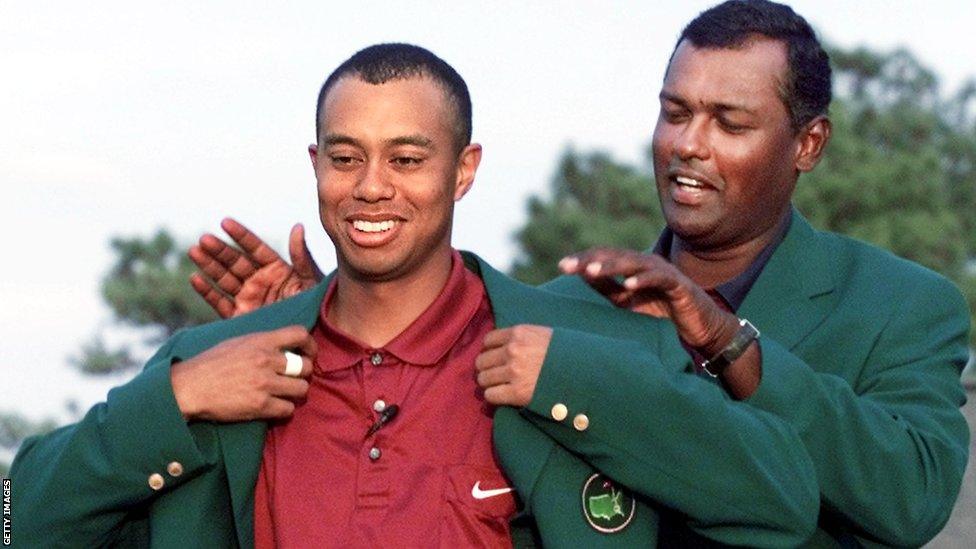 Tiger Woods wins the 2001 Masters and receives his green jacket from Vijay Singh