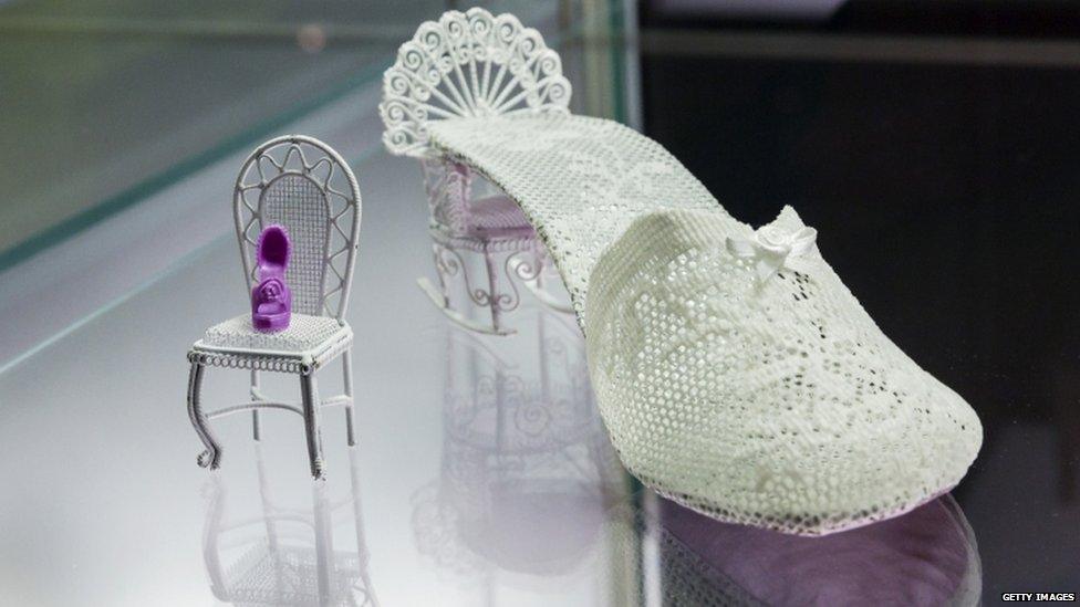 A white shoe with a rocking chair instead of a heel.