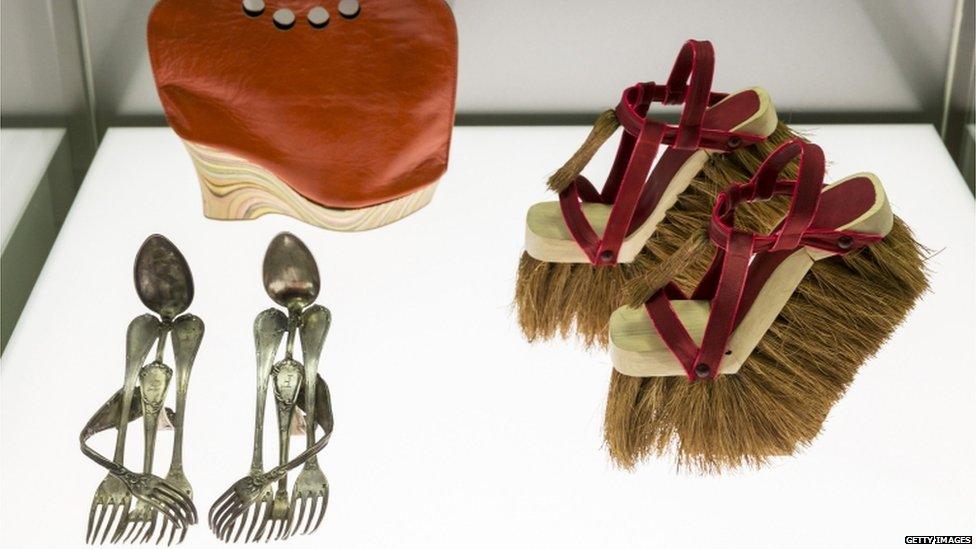 A display showing shoes made from spoons and forks, leather and broom heads.